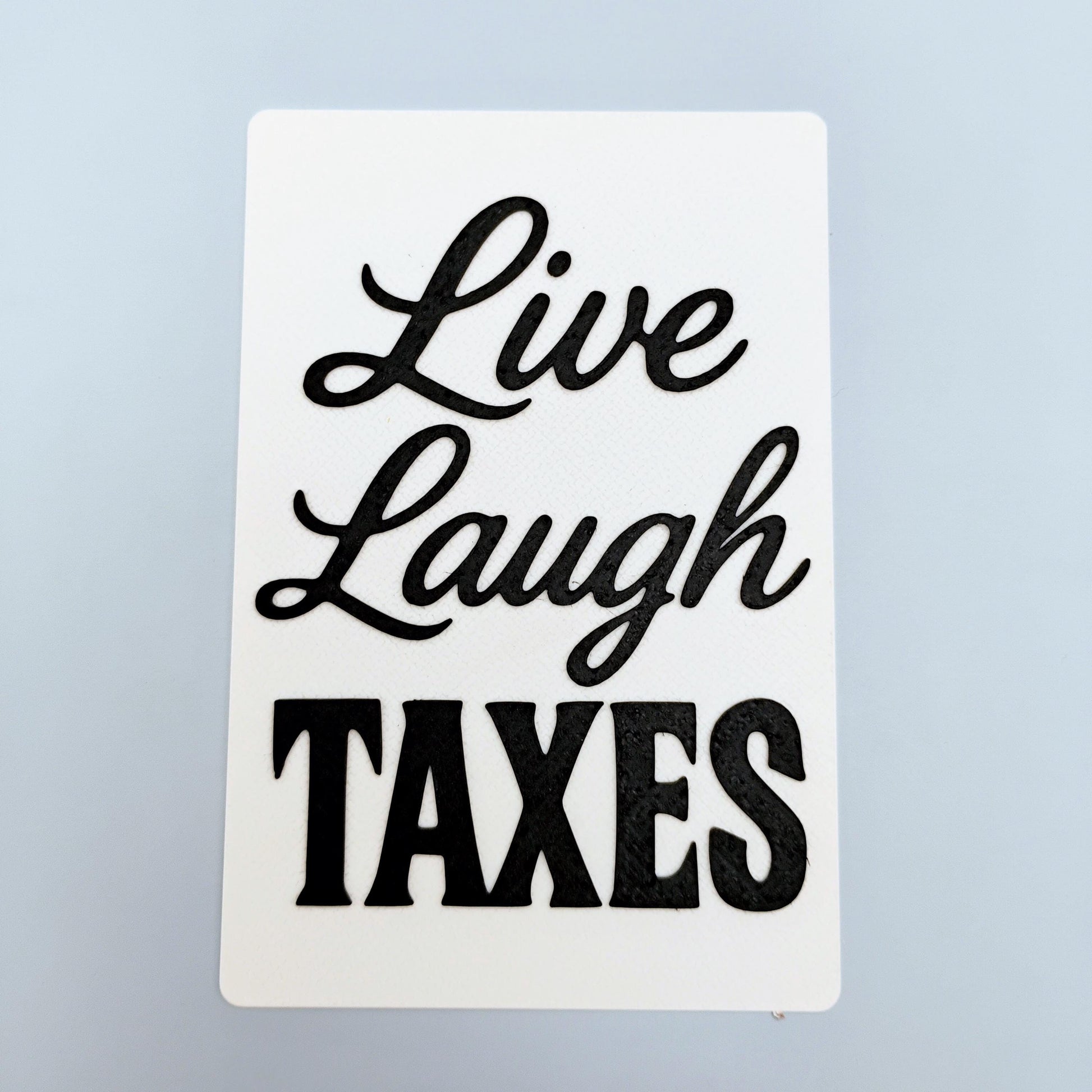 Live Laugh Taxes funny 4x6 sign with black lettering on a white background