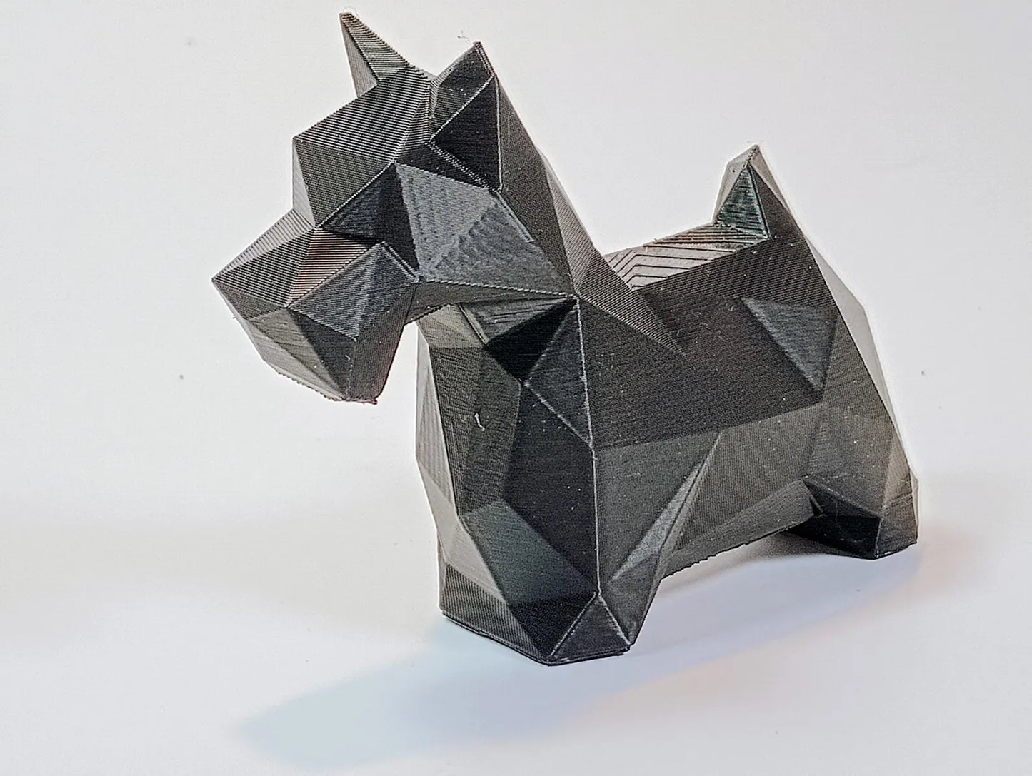 Black low-poly Scottie dog figurine shown from the side as modern dog decor