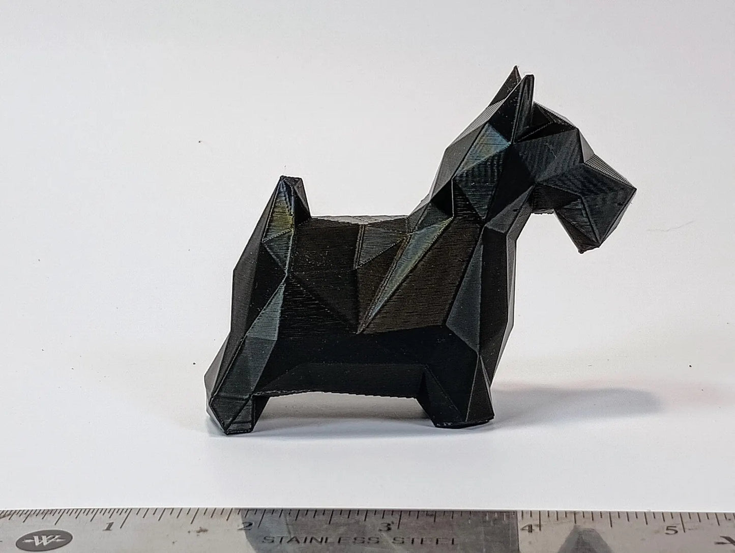 Black low-poly Scottish Terrier figurine with geometric faceted detail shown from the side