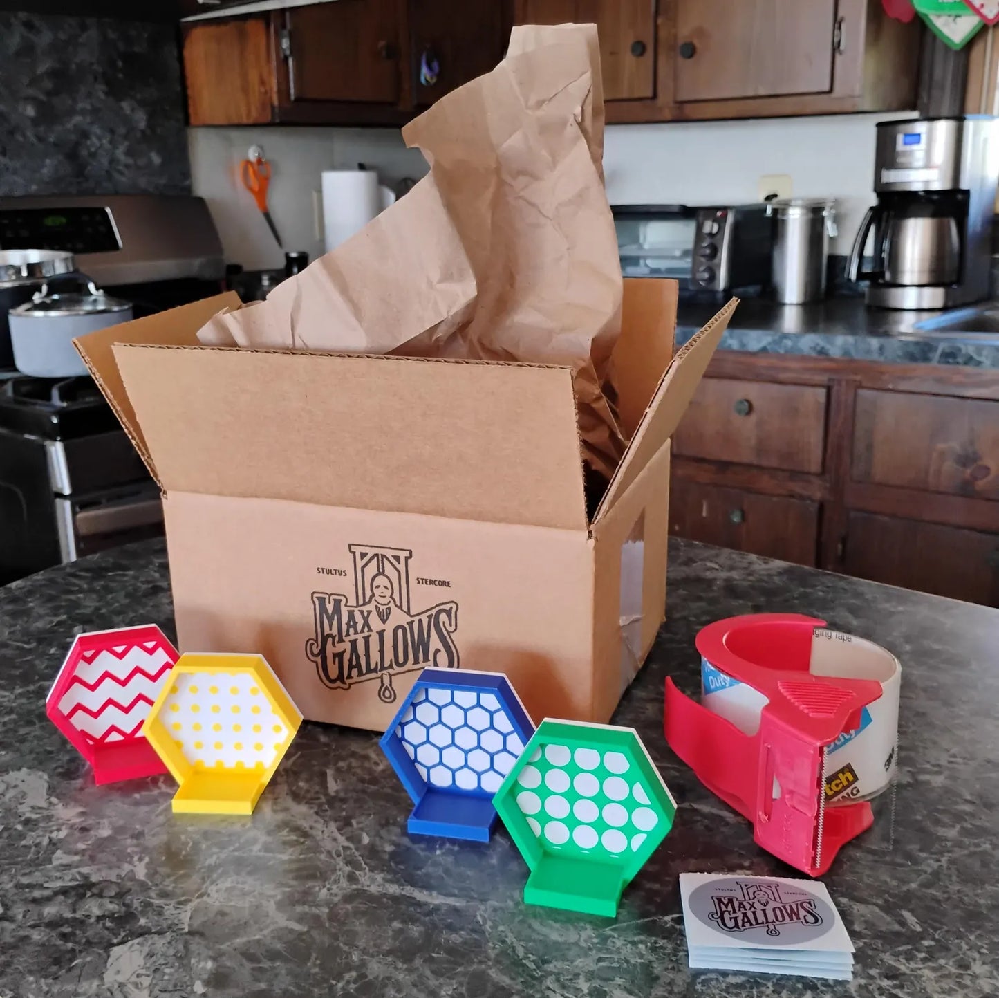 Magnetic hexagon minifigure display set shown with open shipping box, colorful frames, mounts, and included display parts.