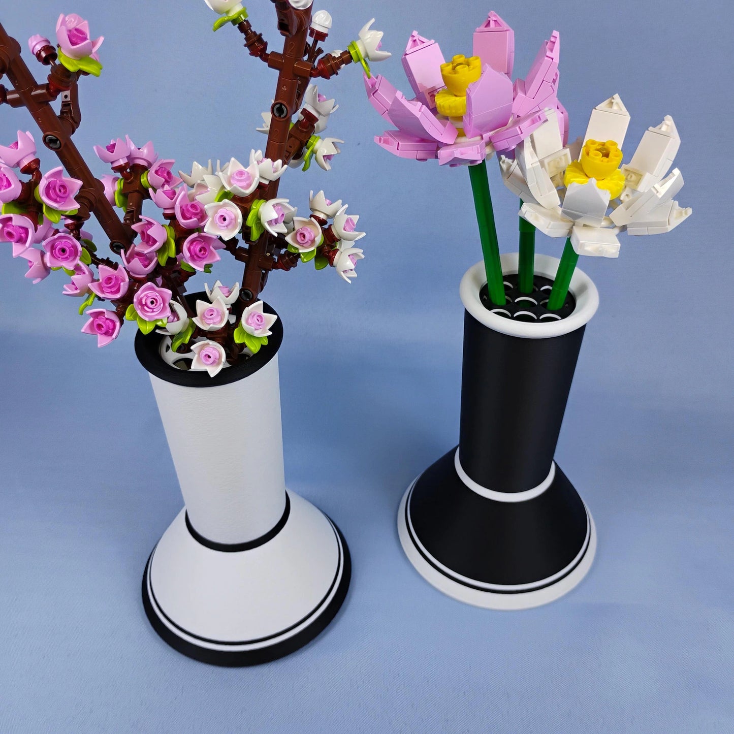 Black and white minimalist vases holding LEGO® botanical flowers as modern decor