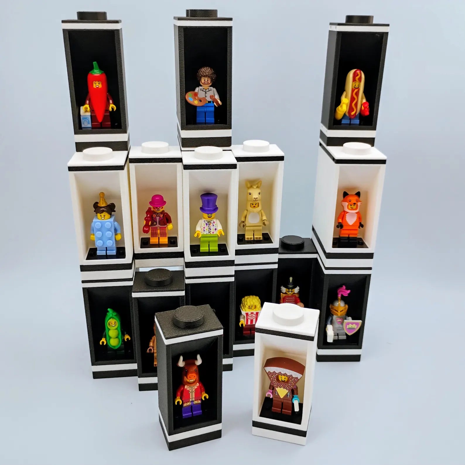 Modular display system for LEGO® minifigures shown in black and white clip-together towers