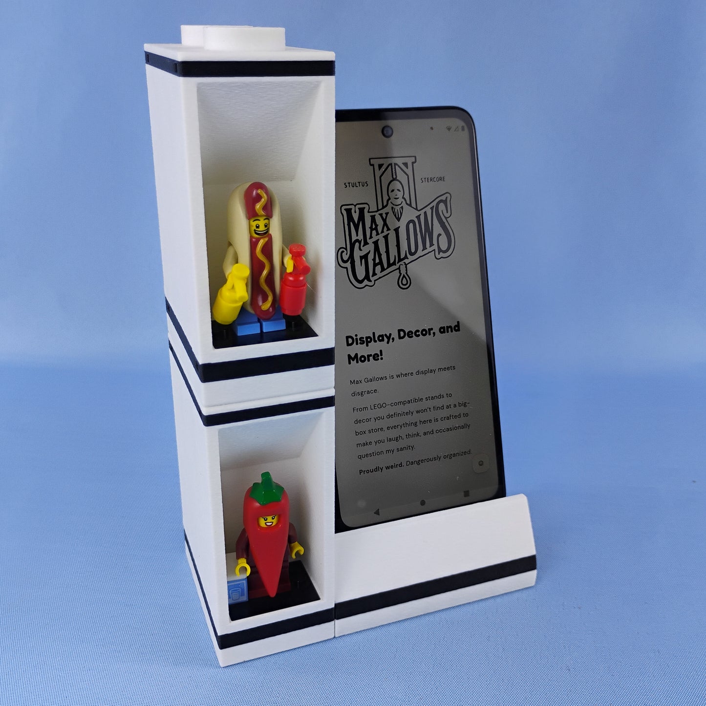 Phone stand with LEGO® minifigure display bricks stacked vertically beside a smartphone to demonstrate the modular system.
