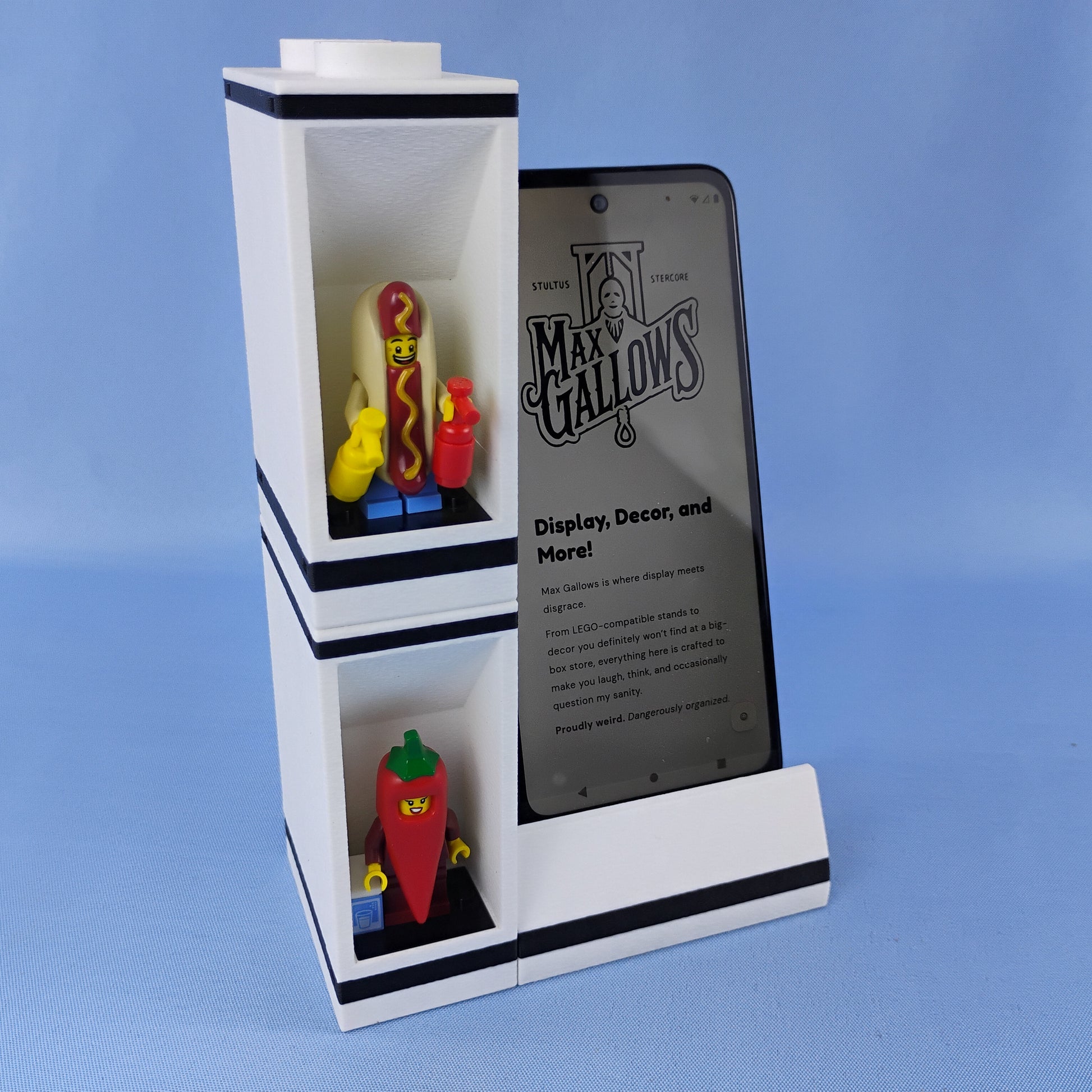 Phone stand with LEGO® minifigure display bricks stacked vertically beside a smartphone to demonstrate the modular system.