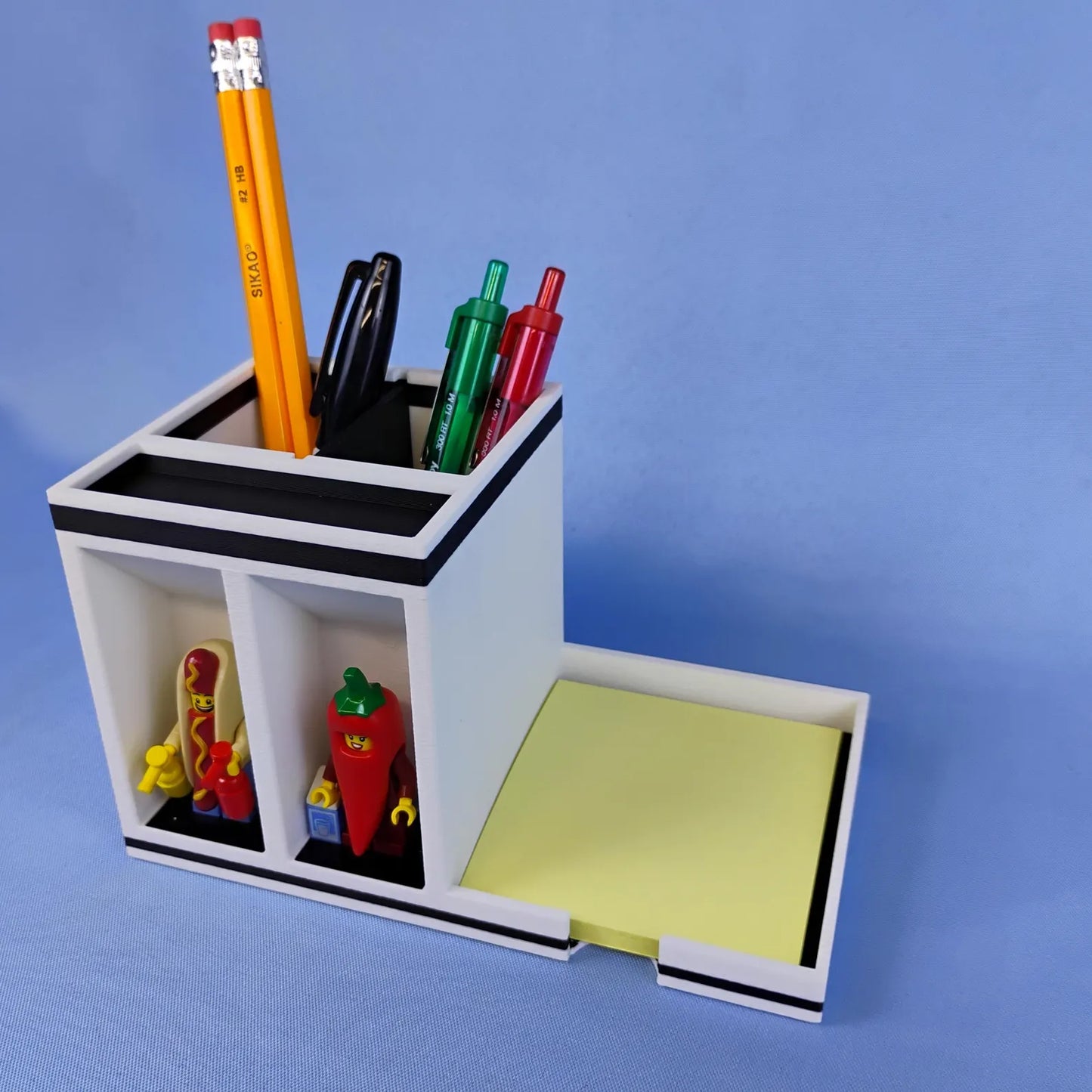 Angled view of Post-it Note desk organizer with pens, pencils, scissors, sticky notes, and minifigure display spots