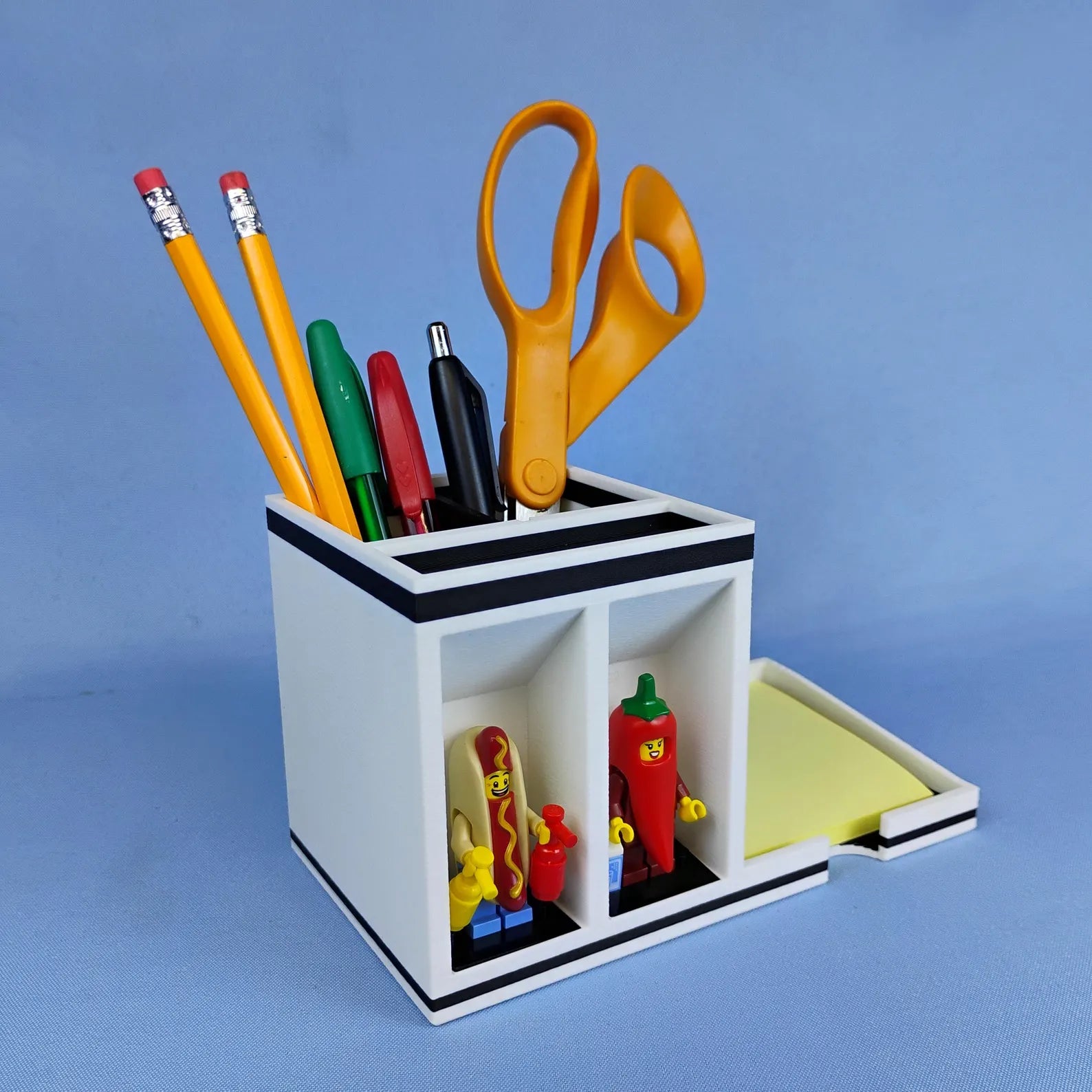 Side angle of Post-it Note desk organizer with sticky note tray, pens, scissors, and minifigure display spots