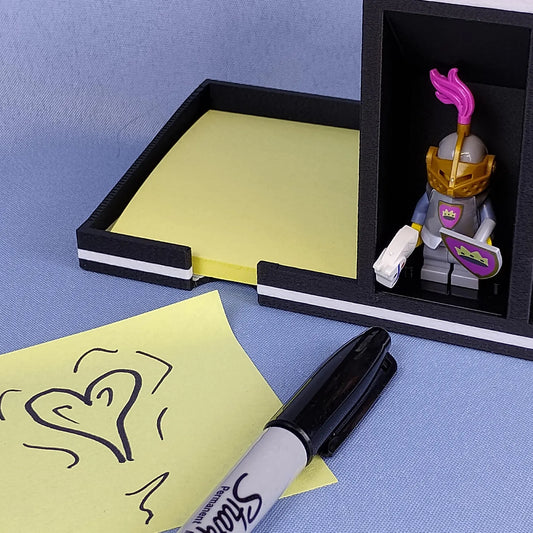 Post-it Note holder with LEGO® minifigure display spot and sticky notes shown with a marker