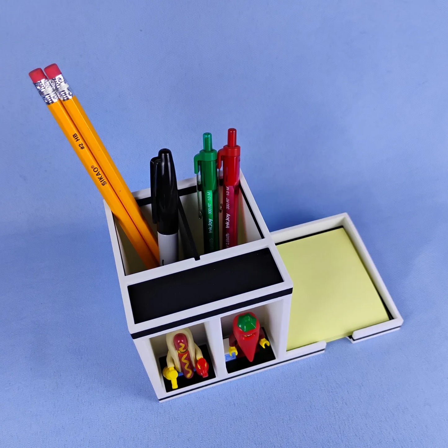 Top view of Post-it Note desk organizer with pen compartment, sticky note tray, and minifigure display plates