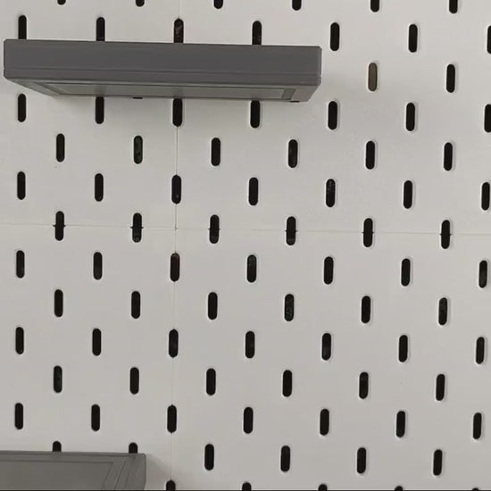 Product video thumbnail showing SKADIS floating shelves mounted on pegboard