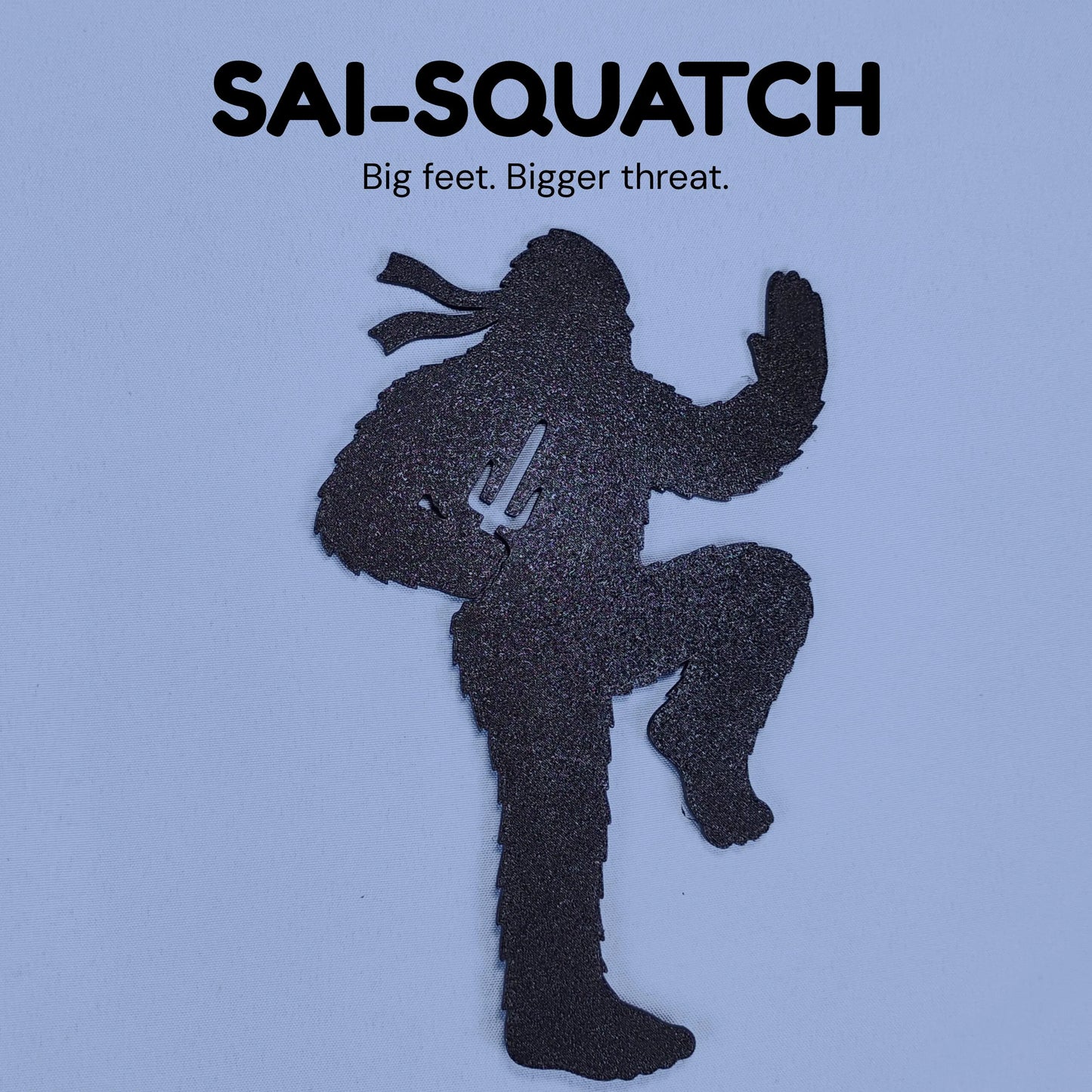 Sai-Squatch Ninja Bigfoot silhouette holding two sai weapons with the caption Big feet, bigger threat.
