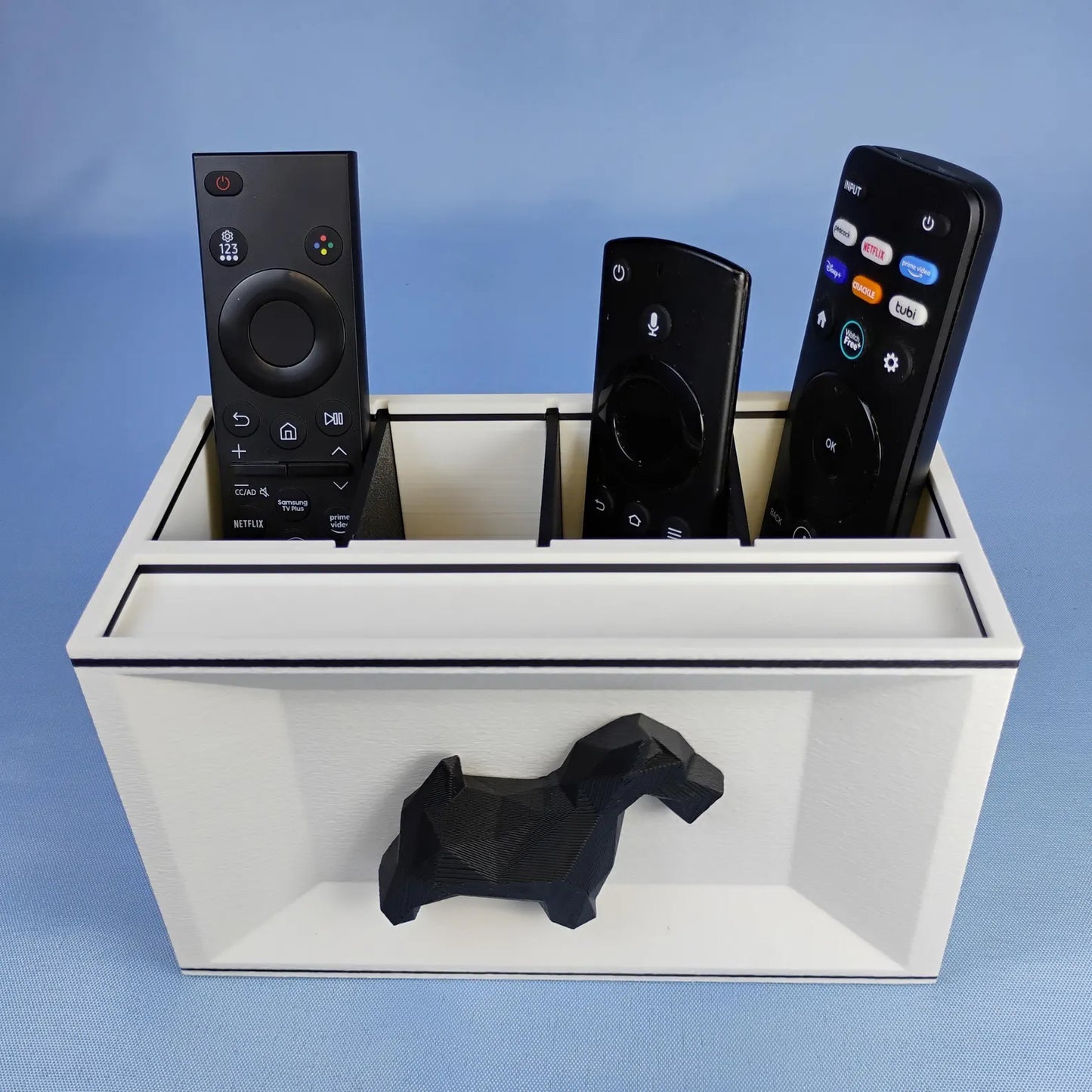 White Scottish Terrier desk organizer holding TV remotes with raised black dog detail on the front