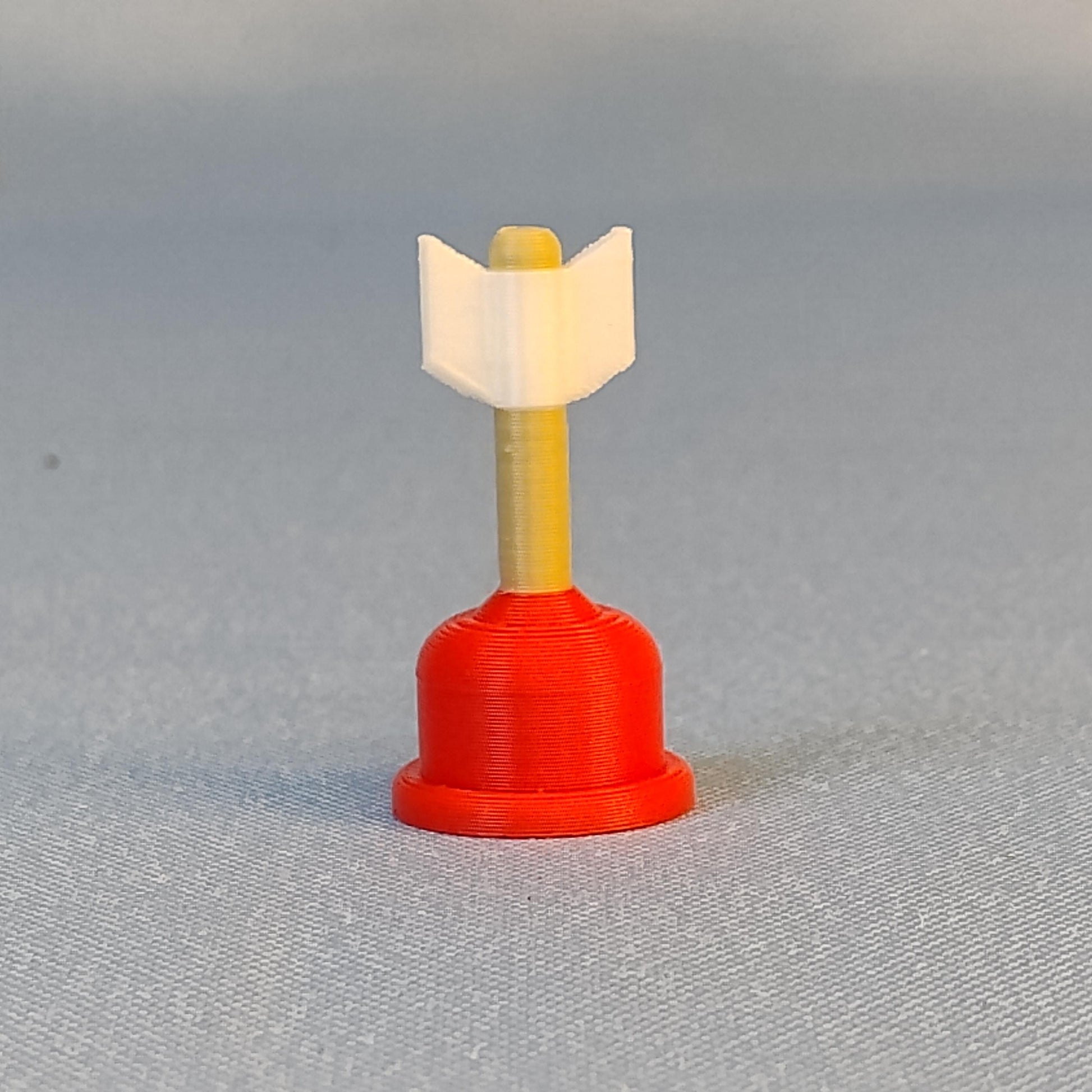 Single mini plunger Cupid arrow magnet with red plunger base, gold shaft, and white arrow tip shown on a blue background.