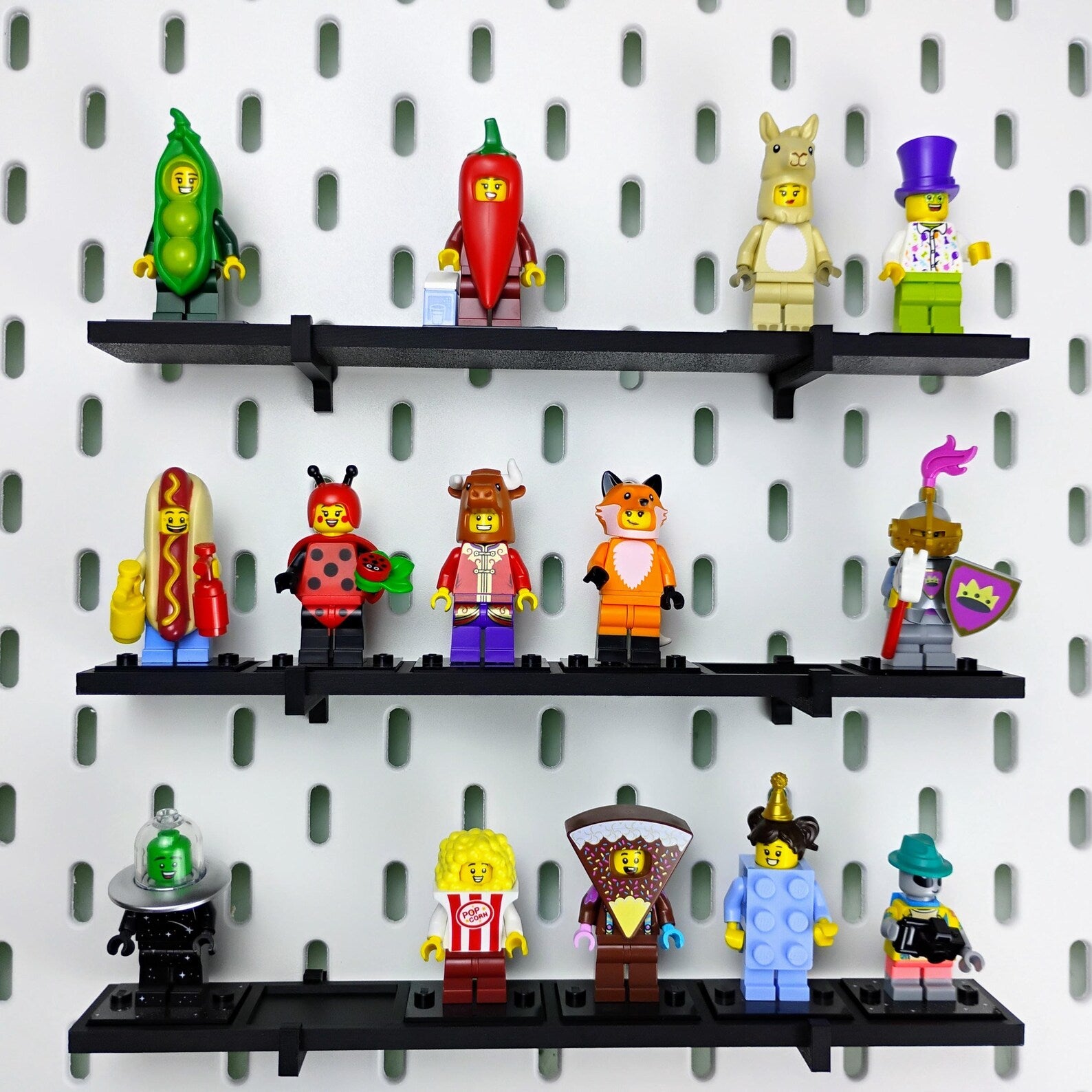 LEGO® minifigures displayed on black SKADIS compatible shelves mounted to an IKEA pegboard