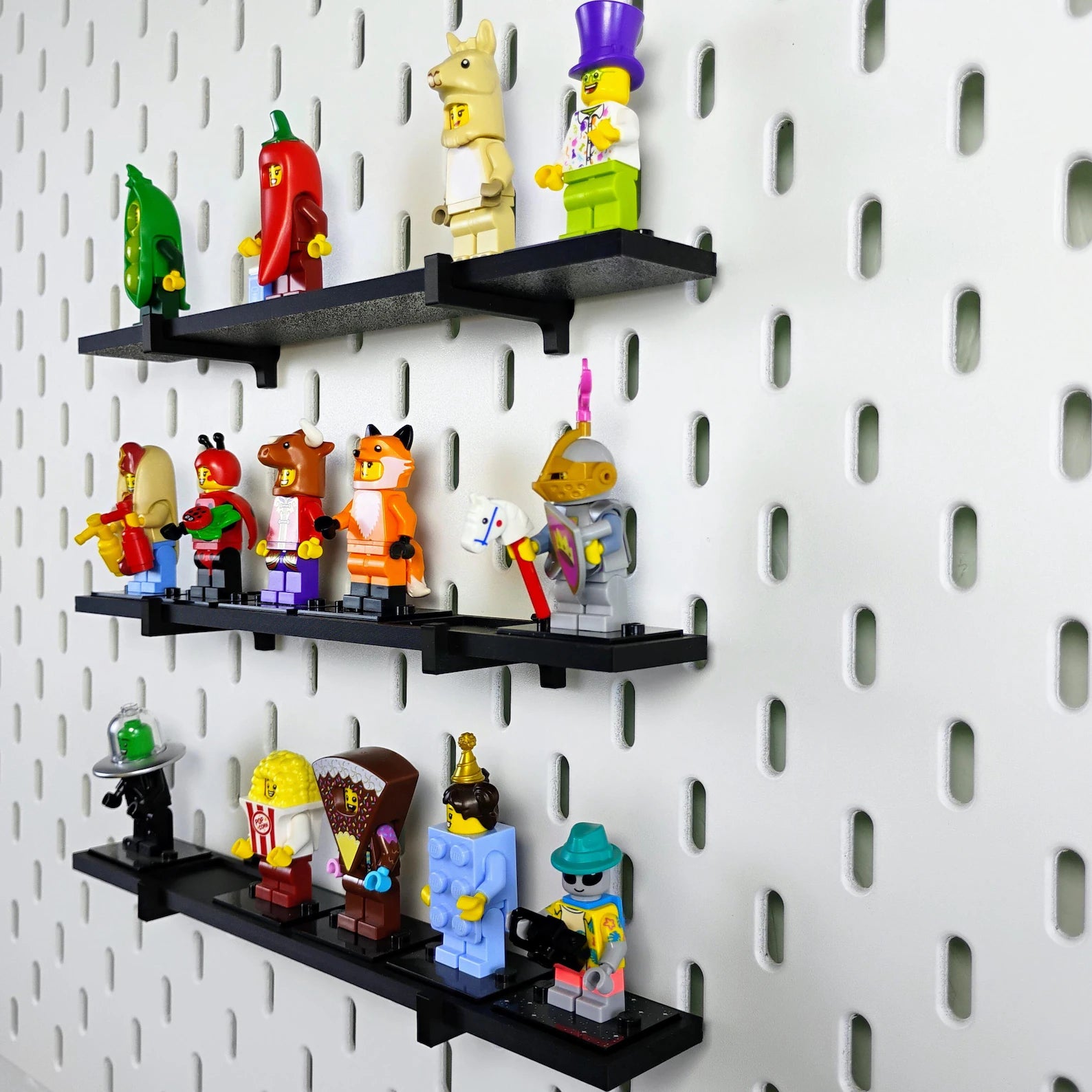 Black SKADIS pegboard shelves arranged as a wall display for LEGO® minifigures