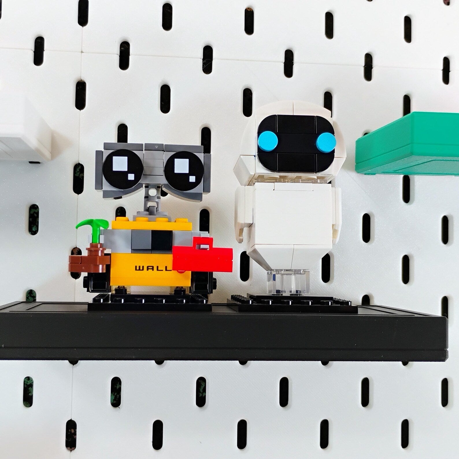 Black SKADIS floating shelf displaying small LEGO® builds and figures