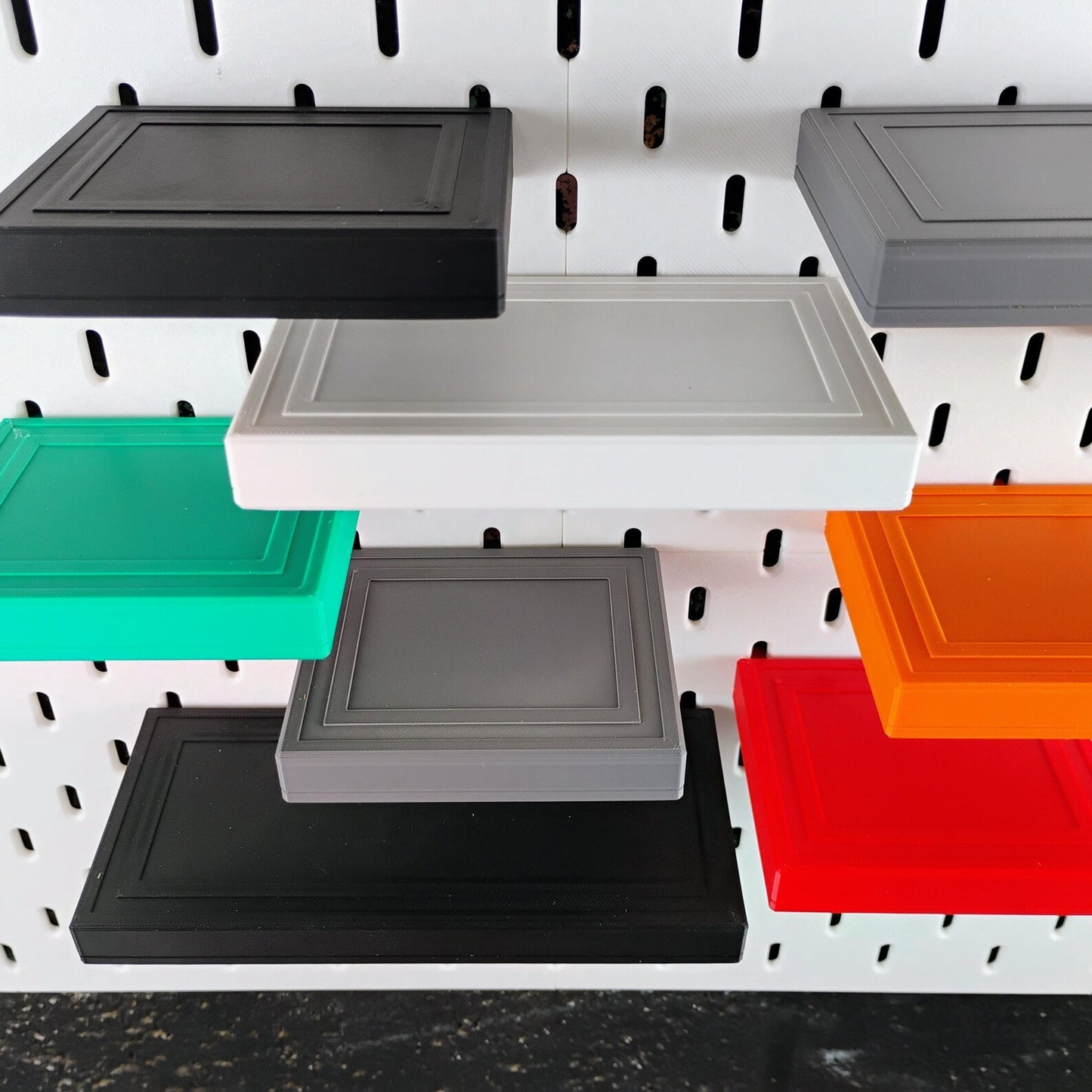 Multiple SKADIS floating shelves shown in different sizes and colors