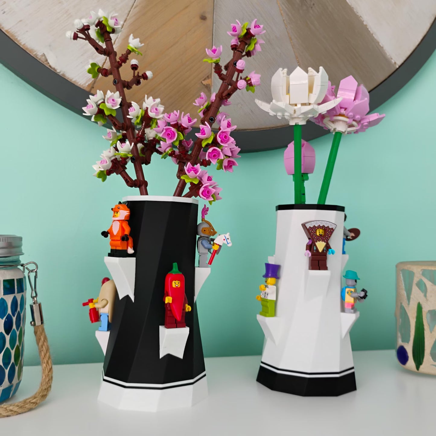 Black and white vases holding LEGO® botanical flowers with built-in shelves for minifigure displays