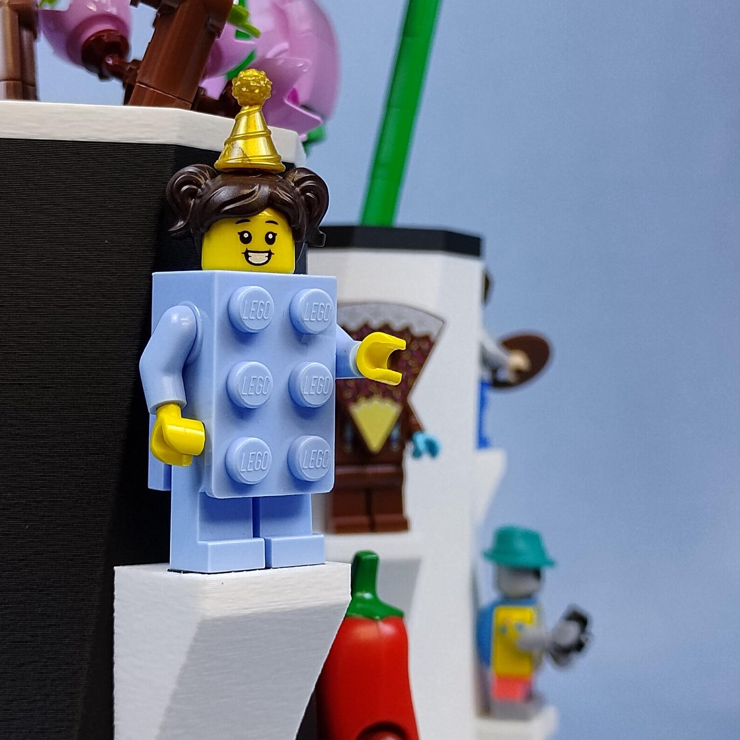 Close-up of LEGO® minifigure displayed on a built-in shelf on the side of the vase