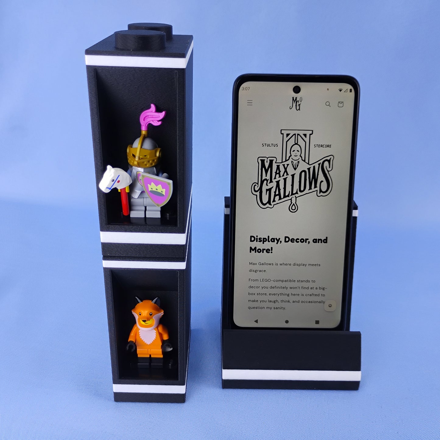 Tall stacked LEGO® minifigure display module positioned beside the modular phone stand with a smartphone.