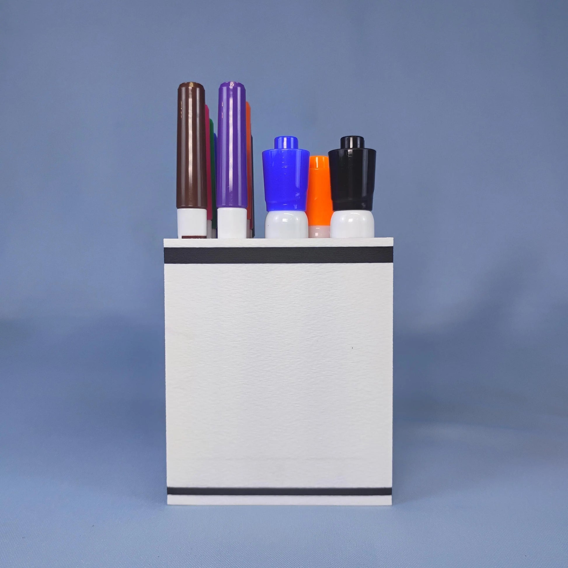 Side and rear view of a white dry erase marker holder showing its compact rectangular shape and tiered storage for two sizes of Expo-style markers.