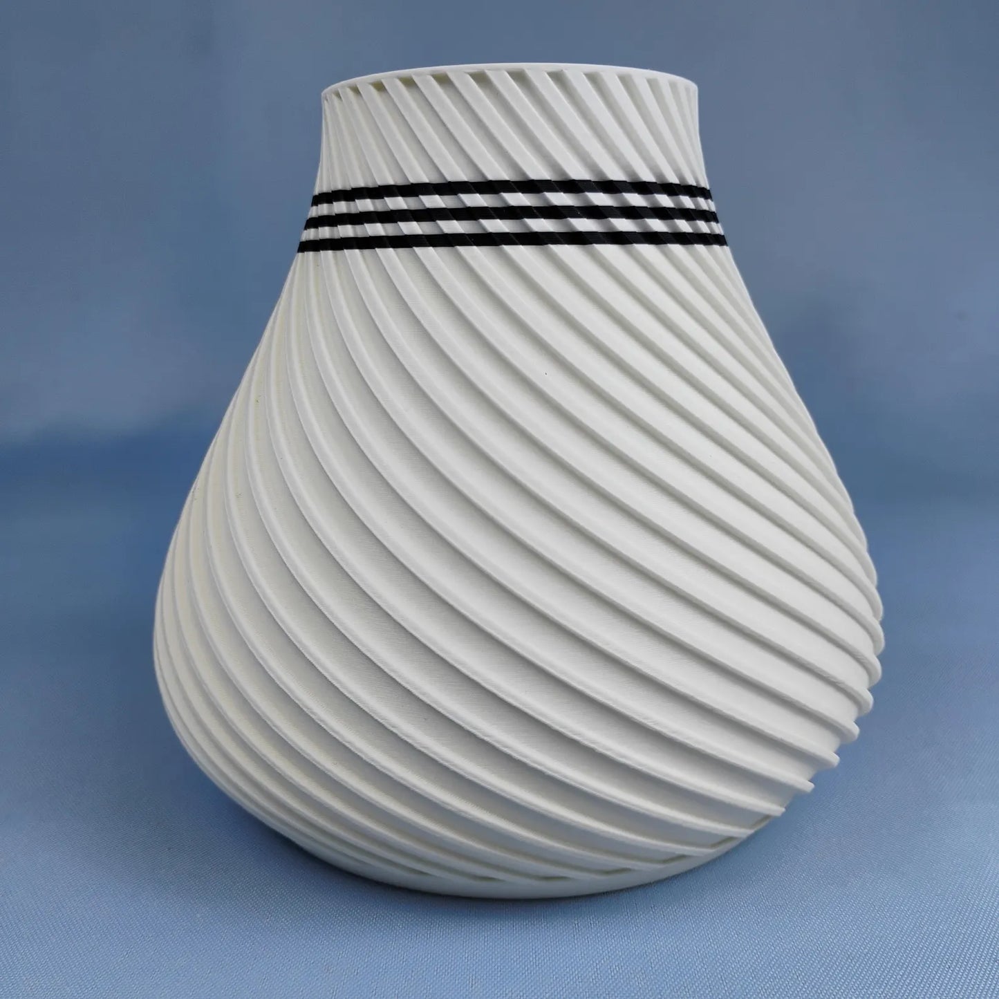White swirly vase with rounded modern shape and spiral surface texture