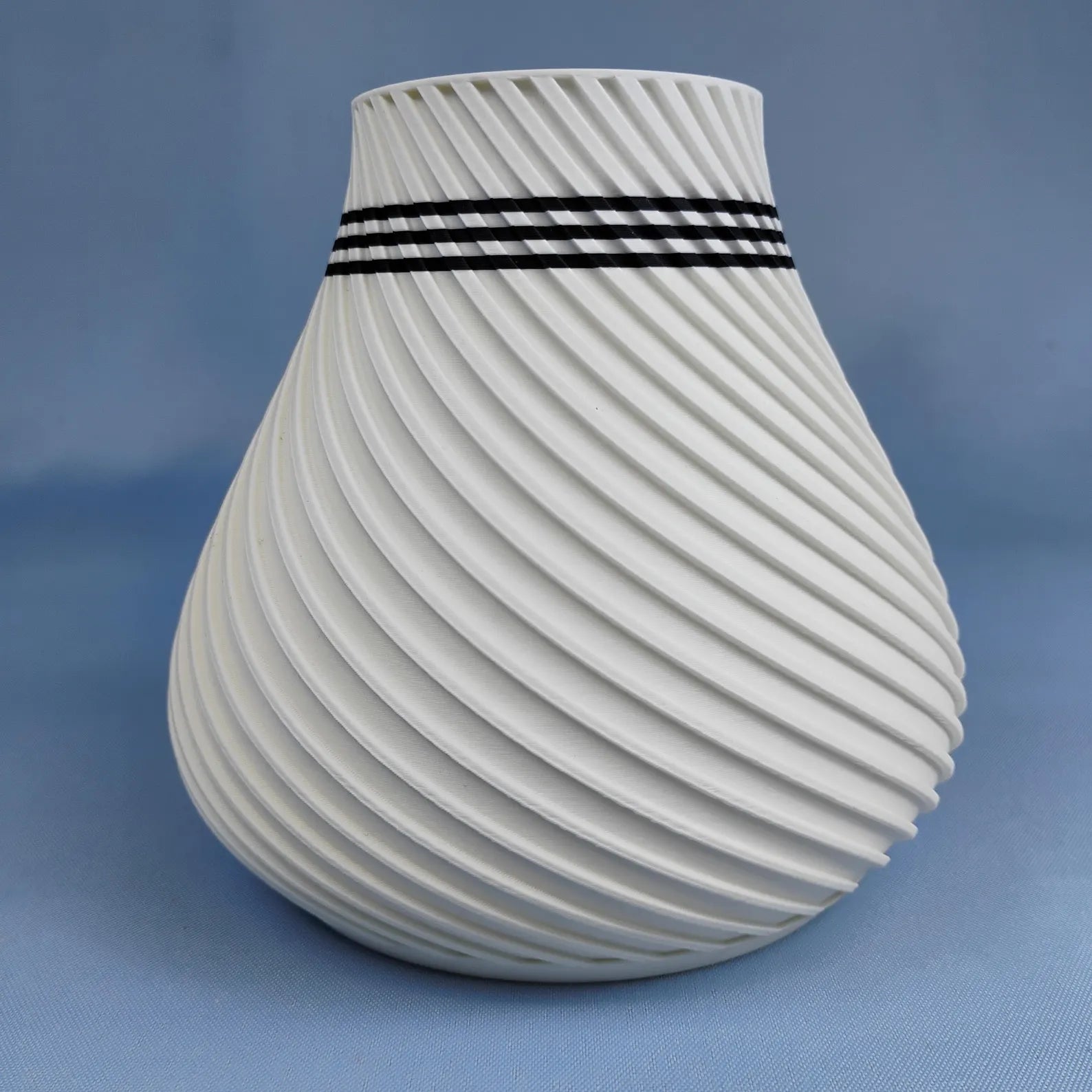 White swirly vase with rounded modern shape and spiral surface texture