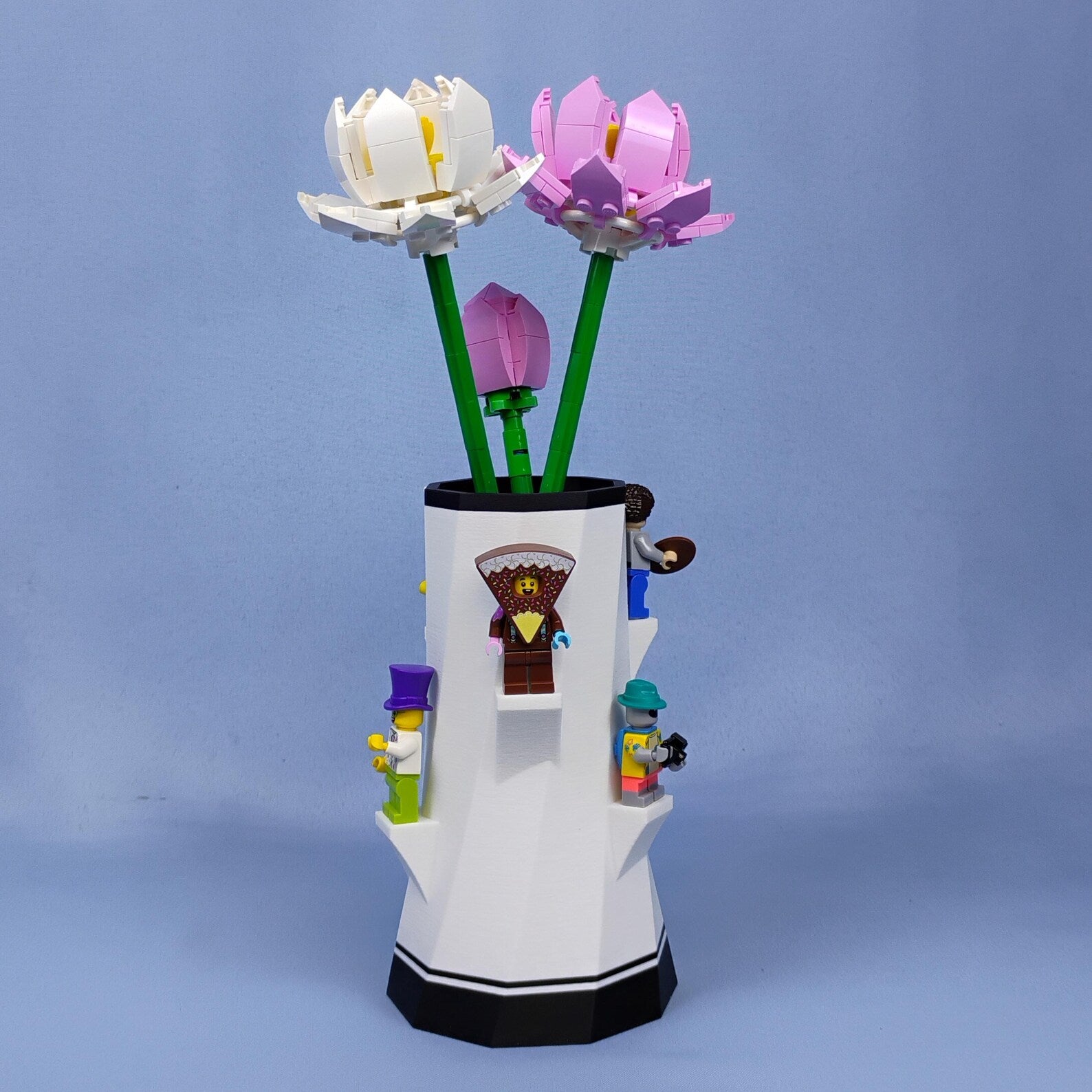White vase holding LEGO® botanical flowers with built-in minifigure display shelves
